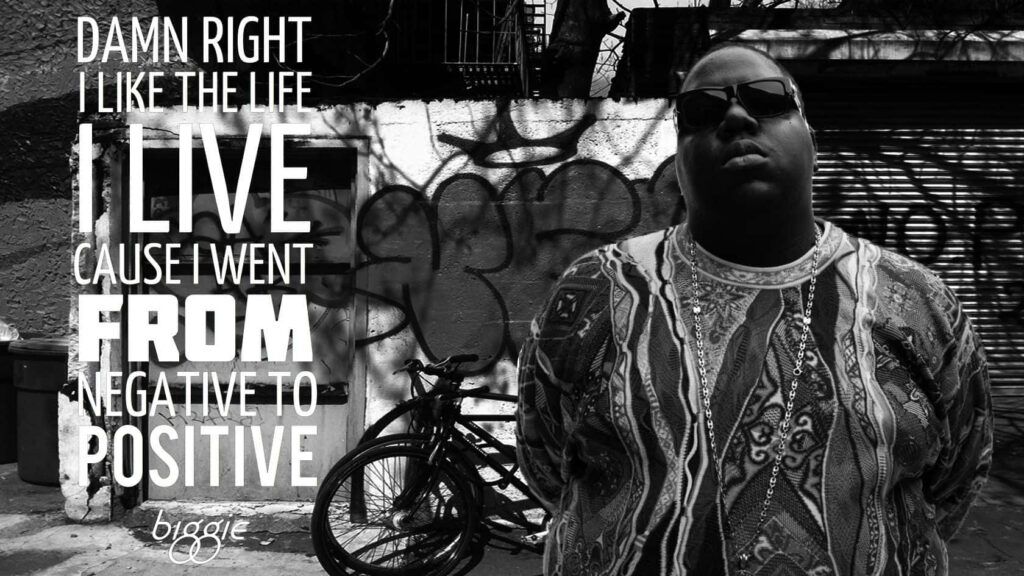 The Notorious B.I.G. in front of graffiti wall with inspiring overcoming adversity quote wallpaper background
