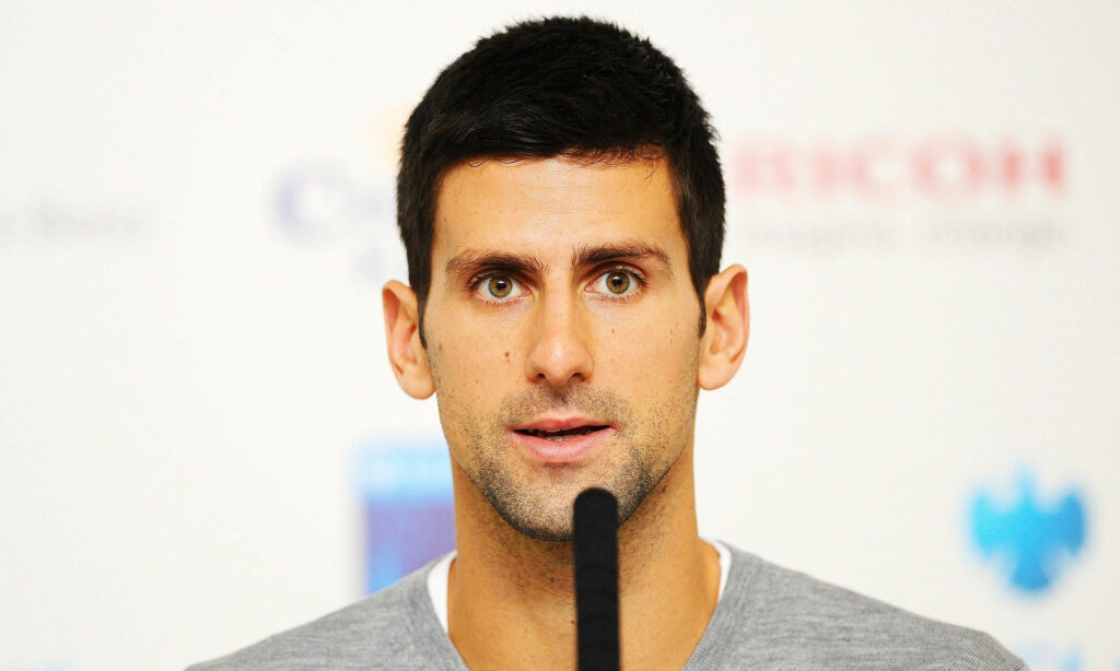 Novak Djokovic Wallpaper: Focused Tennis Star Background