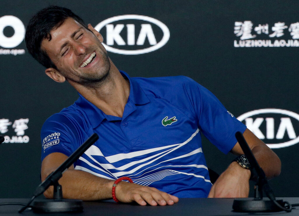 Novak Djokovic Smiling at Press Conference - Charismatic Wallpaper