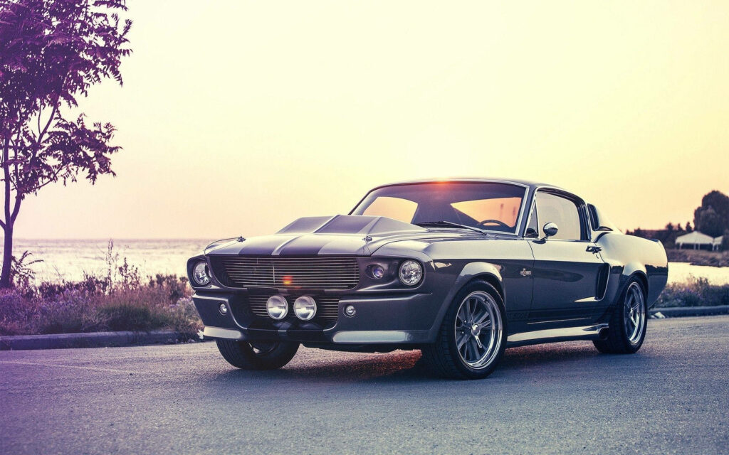 Black Beauty: Vintage Shelby Mustang Muscle Car by the Sea Wallpaper