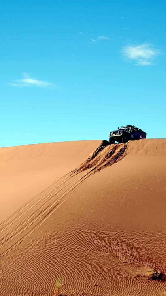 Off-Roading Adventure: LG G4 Jeep Parked over Majestic Sand Dune Wallpaper