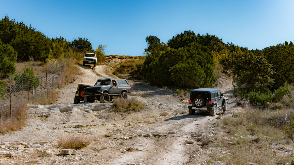Three SUVs Conquer Off-Road Trail in Stunning Natural Landscape Wallpaper