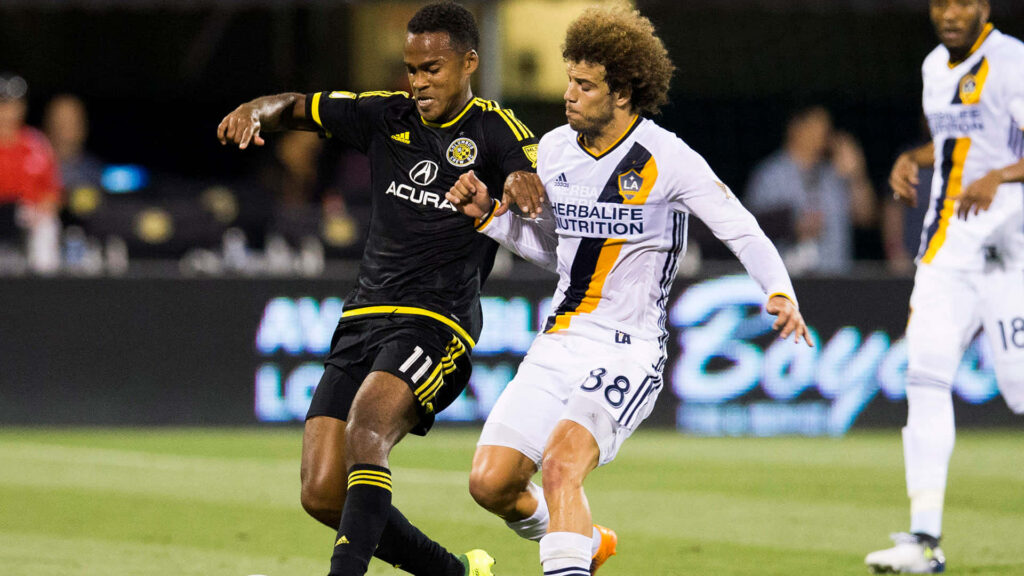 Ola Kamara of Columbus Crew SC battles LA Galaxy defender in intense Major League Soccer match Wallpaper