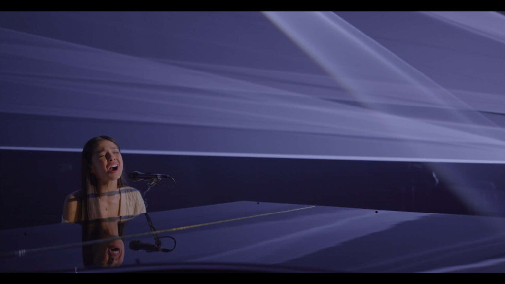 Olivia Rodrigo Piano Performance Wallpaper - Serene Background Art