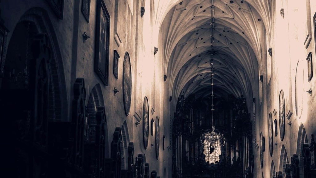 Oliwa Cathedral interior with ribbed vaulted ceilings historic paintings and dramatic lighting wallpaper