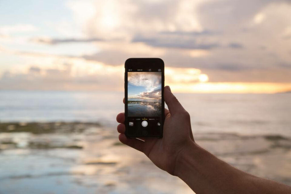 One-Handed iPhone Photography: Capturing Majestic Scenery and Clouds Wallpaper