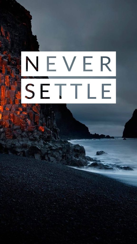 OnePlus Nord wallpaper volcanic seashore twilight dark cliffs waves bold Never Settle slogan