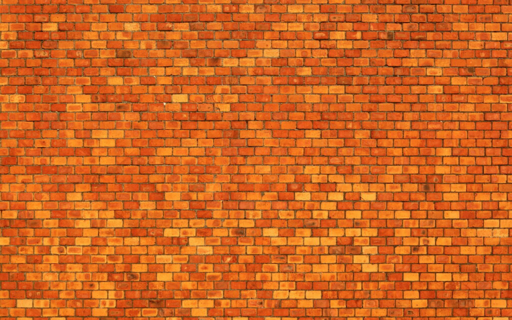 Macro Capture of Vibrant Orange Brick Wall: Textured Bricks in Stunning QHD Wallpaper