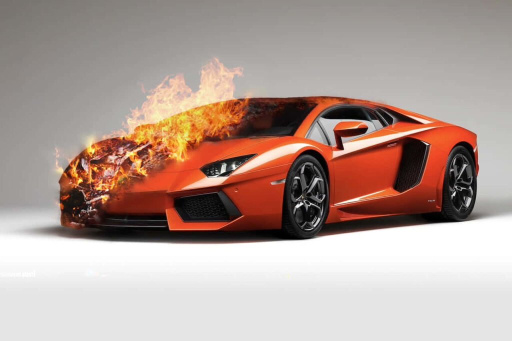 Orange Lamborghini car engulfed in vibrant flames intense automotive wallpaper background