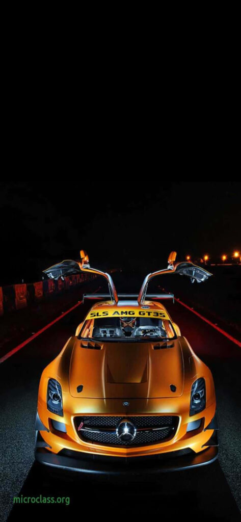Orange Mercedes-Benz SLS AMG GT3 with open gullwing doors on night racetrack showcasing bold design Wallpaper