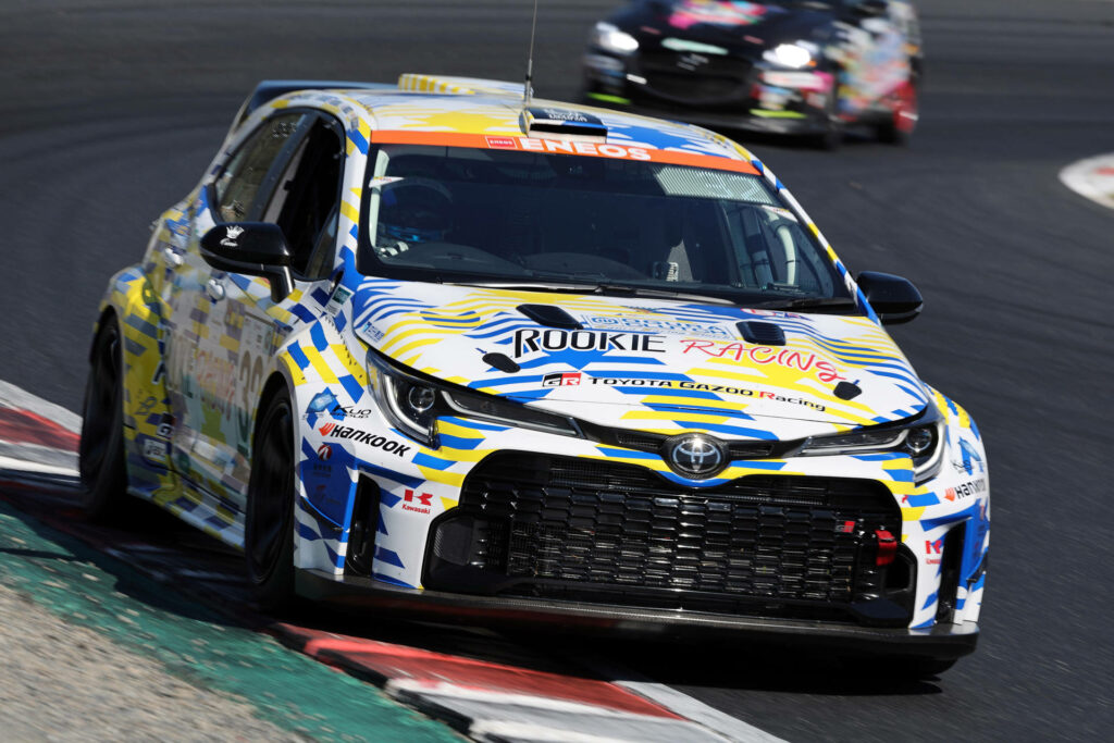 Orc Rookie GR Corolla H2 Concept racing on track with vibrant livery speeding around corner wallpaper
