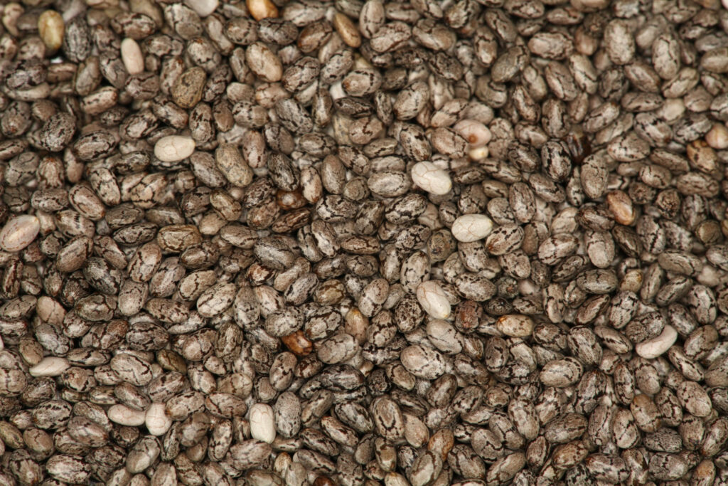 Close-up of chia seeds textured surface natural brown gray white healthy nutrition background Wallpaper