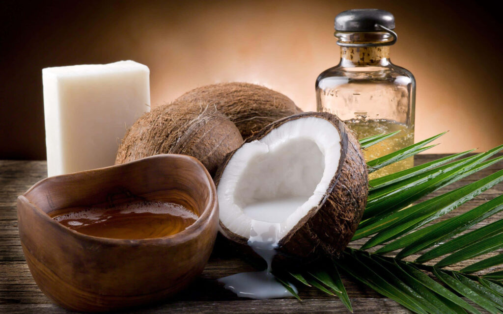 Natural coconut oil spa scene with soap coconuts palm leaves and glass bottle on wood table Wallpaper