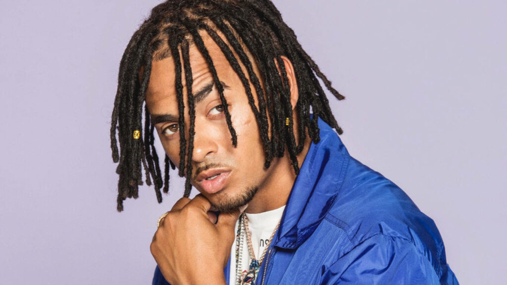 Ozuna Wallpaper: Confident Pose in Blue Jacket & Purple Background