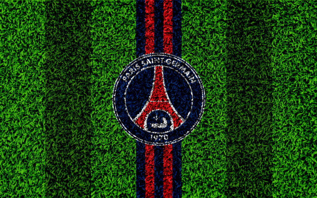 PSG's Iconic Logo Takes Center Stage on Lush Grass Wallpaper