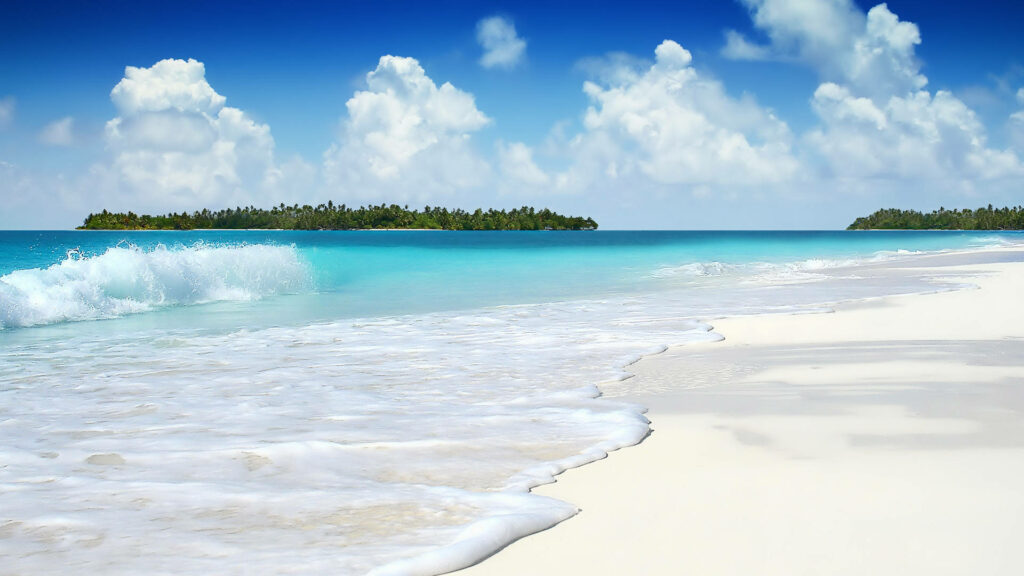 Paradise Calling: Transcendent Beachscape with Azure Waters, Sunlit Sand, and Majestic Isles Wallpaper