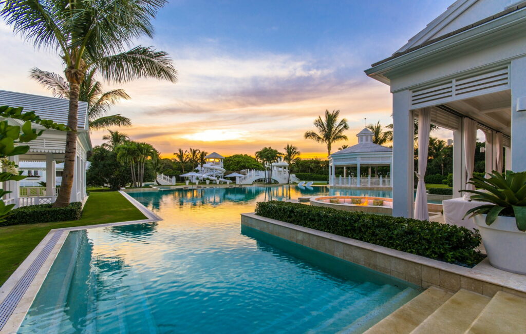 Paradise Retreat: A Spectacular Luxury House Amidst Breathtaking Nature and Serene Sunset Wallpaper