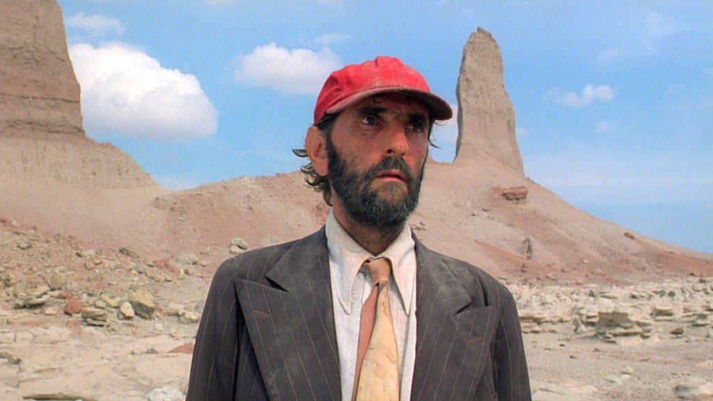 Harry Dean Stanton as Travis Henderson in Paris Texas desert scene with blue sky wallpaper