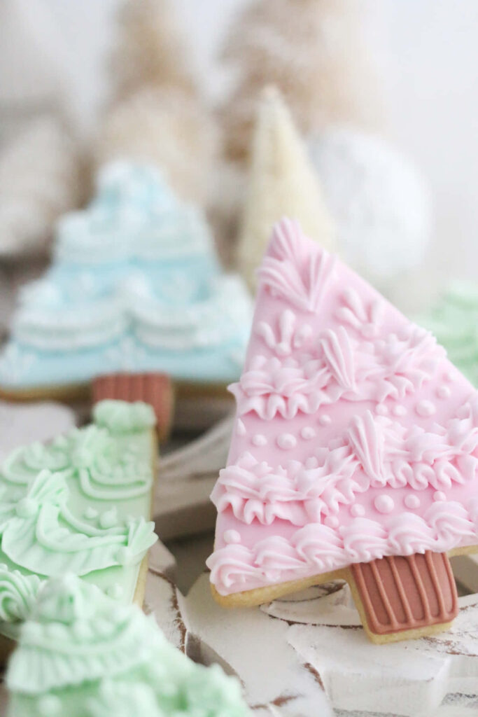 Festive Pastel Christmas Tree Cookies with Intricate Icing Designs Wallpaper