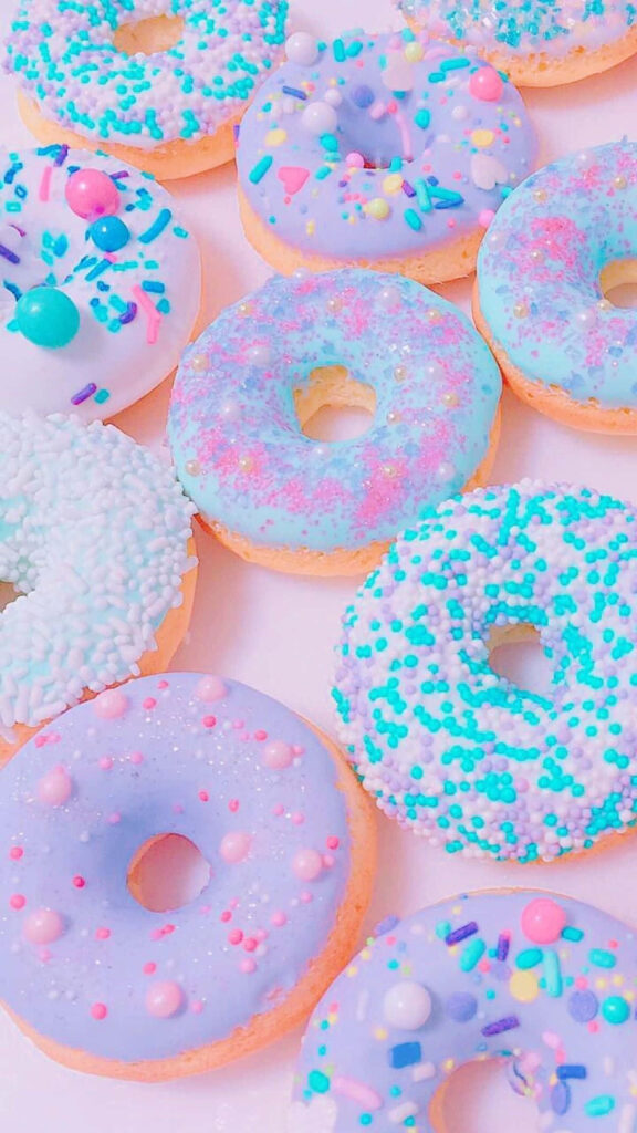 Pastel Donut Wall Art: Delightful Sprinkled Wallpaper Background