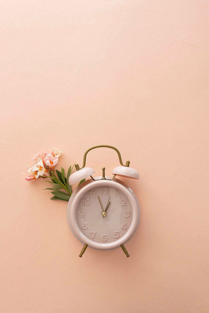 Blooming Memories: A Dreamy Pastel Phone Background Capturing the Delicate Beauty of a Baby Pink Clock Amidst Flowerful Serenity Wallpaper