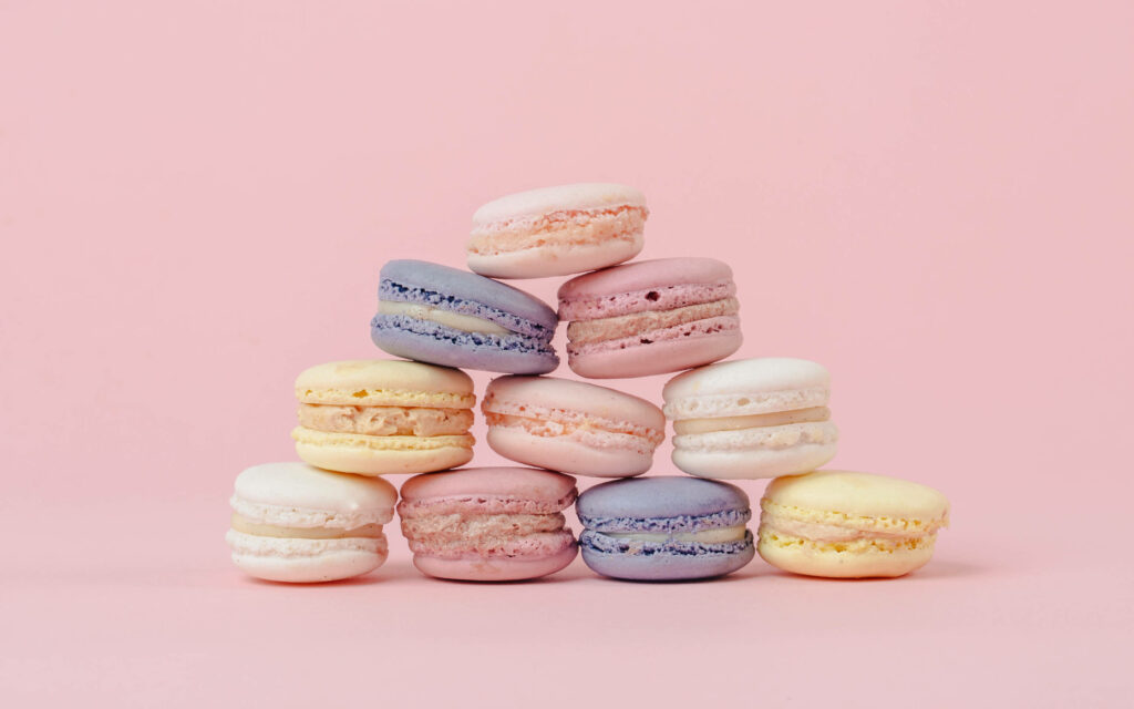 Pastel Macaroons Pyramid Wallpaper on Soft Pink Background