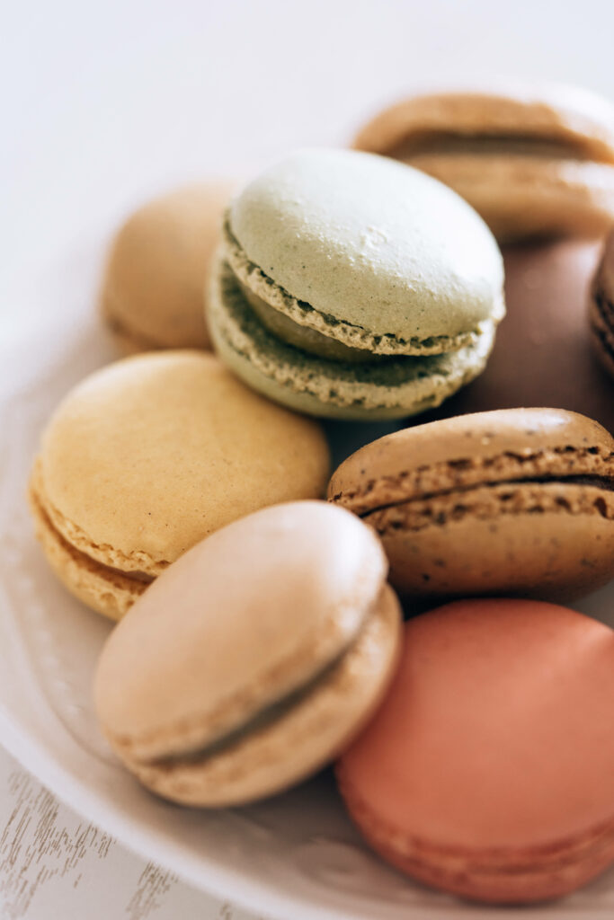 Pastel Macaroon iPhone Wallpaper: Soft Textures on White Plate