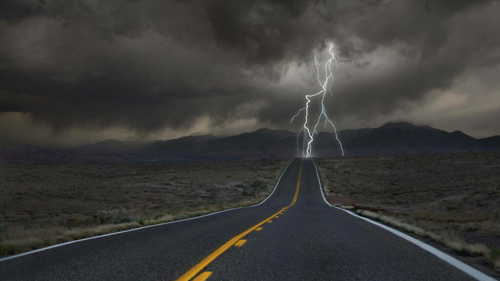Nature's Fury Unleashed: Majestic Thunderstorm at the Horizon - Breathtaking Roadside Wallpaper