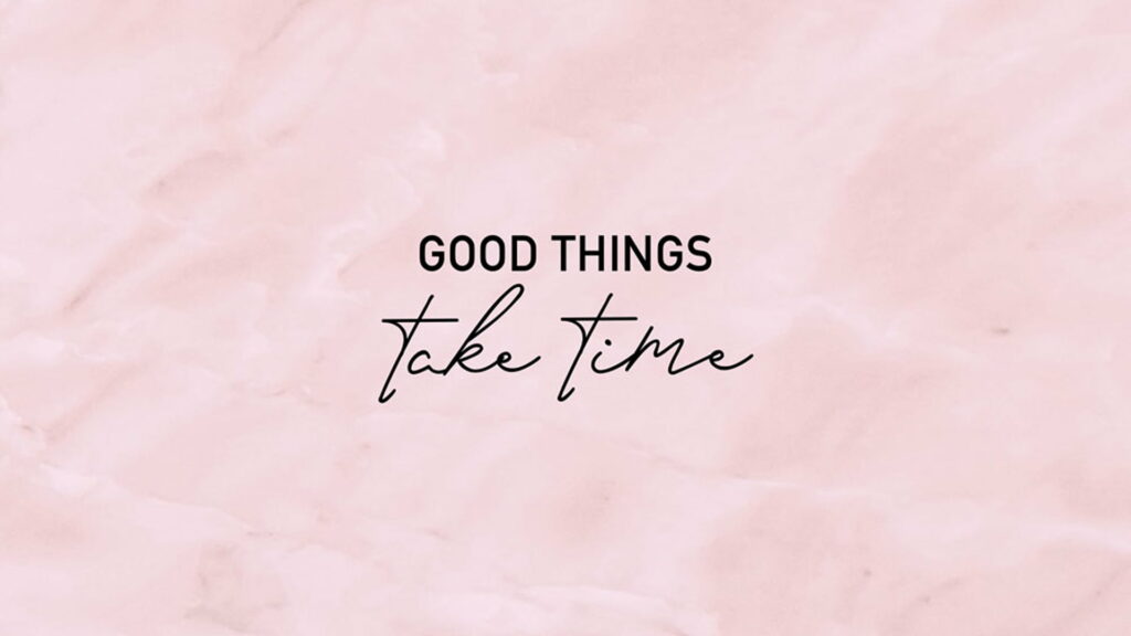 Motivational wallpaper with Good things take time quote in black on pastel pink marble background