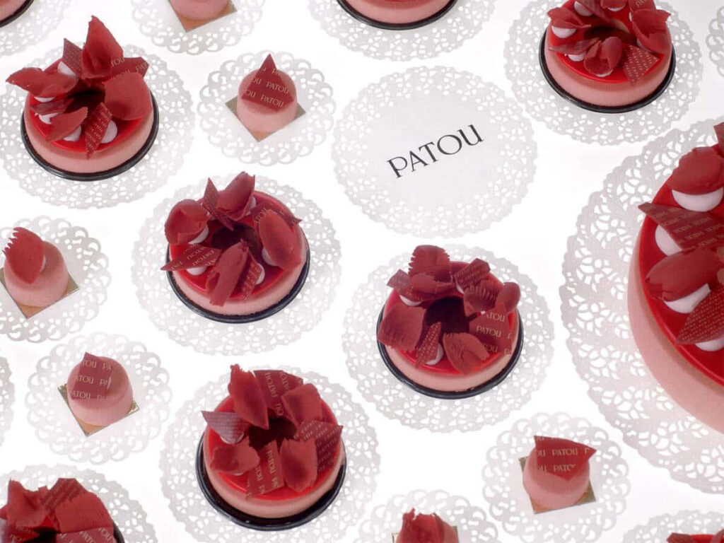 Decadent Delights: Tempting Desserts and Patou Logo Wallpaper