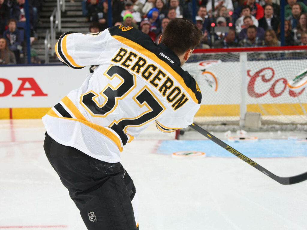 Patrice Bergeron Boston Bruins number 37 intense hockey game action dynamic NHL wallpaper