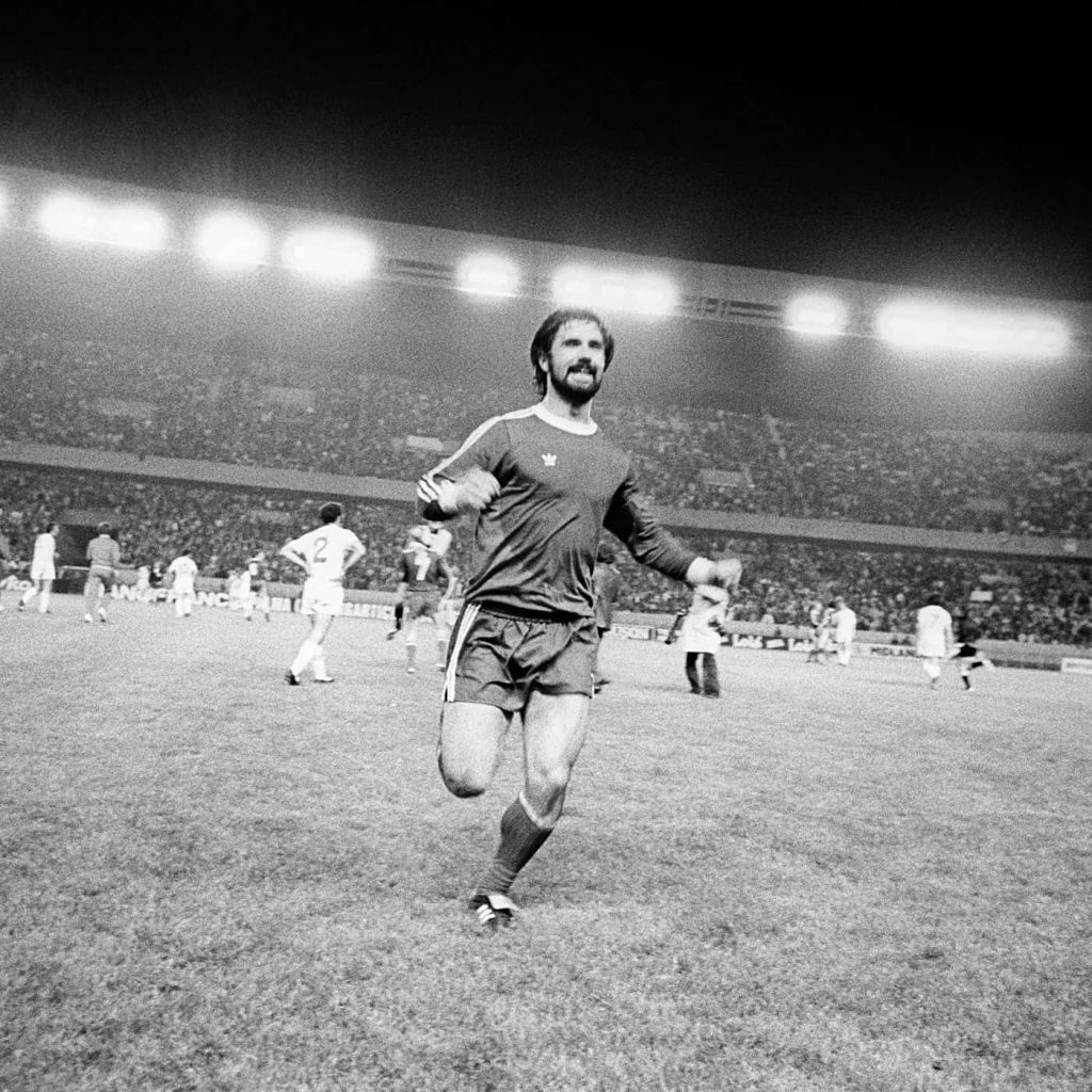 Legendary German footballer Paul Breitner celebrating on pitch vintage black and white wallpaper