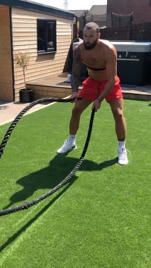 UFC fighter Paul Craig intense battle rope workout outdoors on turf natural sunlight fitness wallpaper