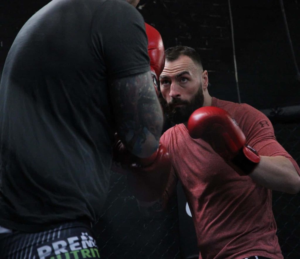 UFC fighter Paul Craig intense MMA training sparring with partner in gym boxing gloves wallpaper