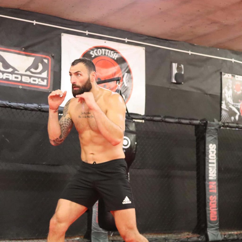 UFC fighter Paul Craig training shirtless at Scottish Hit Squad gym showing defensive skills Wallpaper