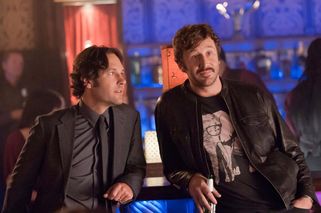Paul Rudd and Chris O'Dowd in warm colorful bar scene from 2012 film This Is 40 wallpaper background