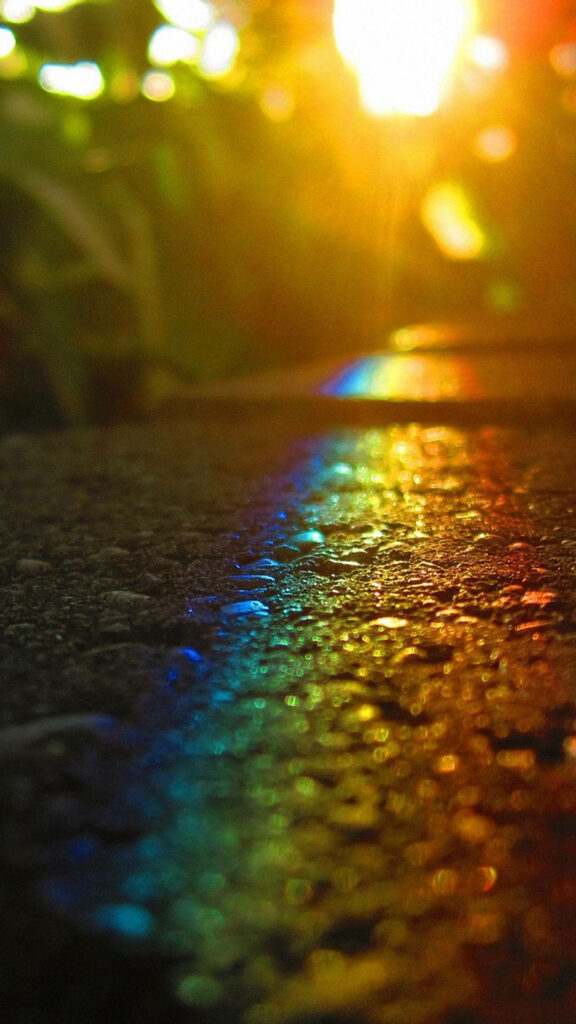 Radiant Sunset Rainbow Embraces Pavement in a Captivating Mobile Wallpaper