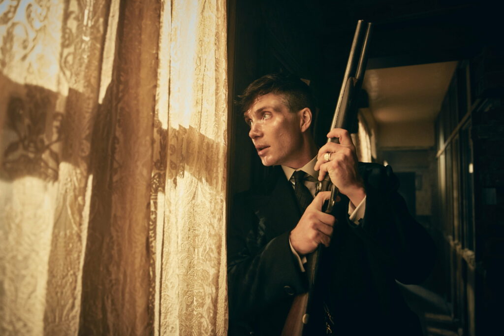 Gritty Shadows: The Intense World of Thomas Shelby in Peaky Blinders Wallpaper