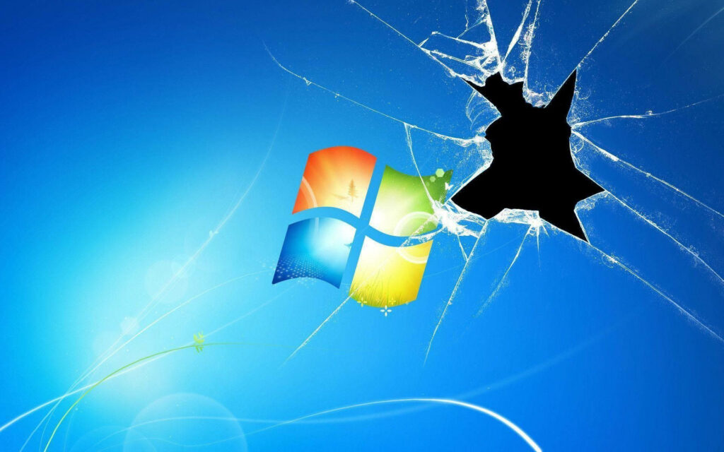 Windows Logo Peeks Through Broken Monitor Hole in Wallpaper Background