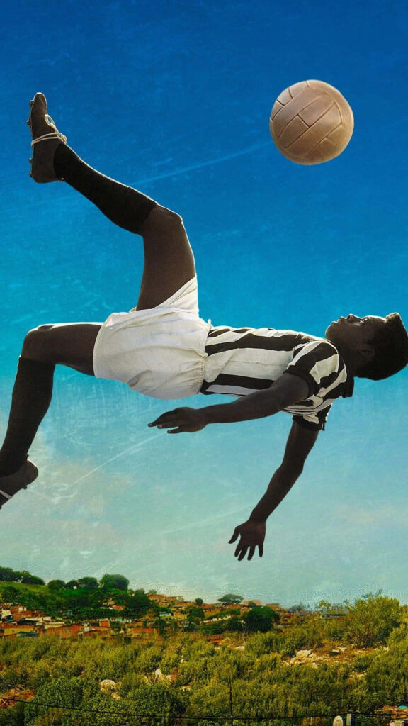 Pelé's Iconic Bicycle Kick Wallpaper Against a Vibrant Blue Sky