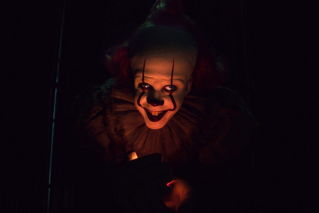 Cinematic close-up of Pennywise the Dancing Clown from It with eerie lighting wallpaper