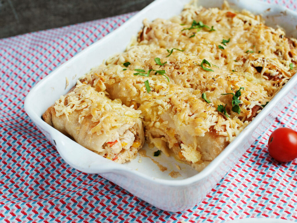 Delicious Cheesy Enchiladas on a Vibrant Cloth: Perfectly Baked Wallpaper
