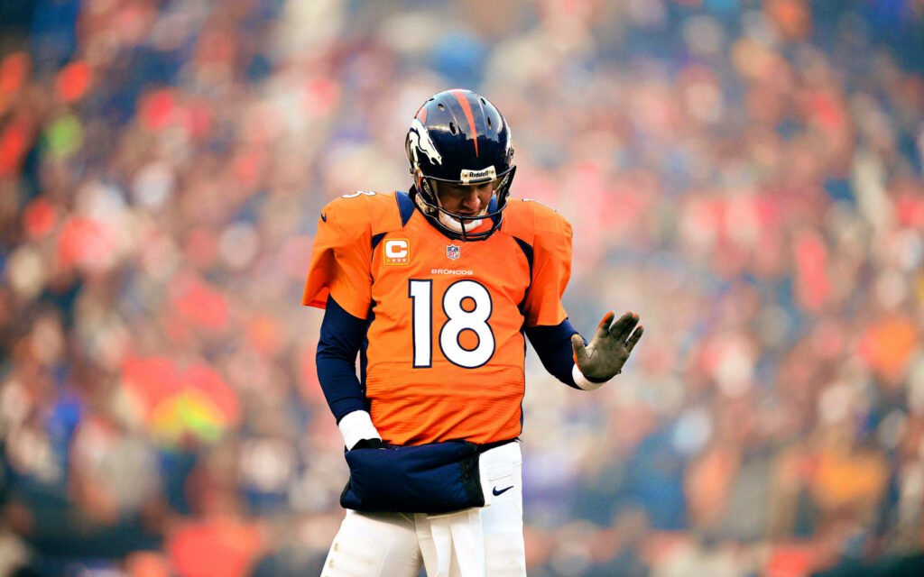 Peyton Manning Denver Broncos number 18 jersey focused on field vibrant orange uniform wallpaper