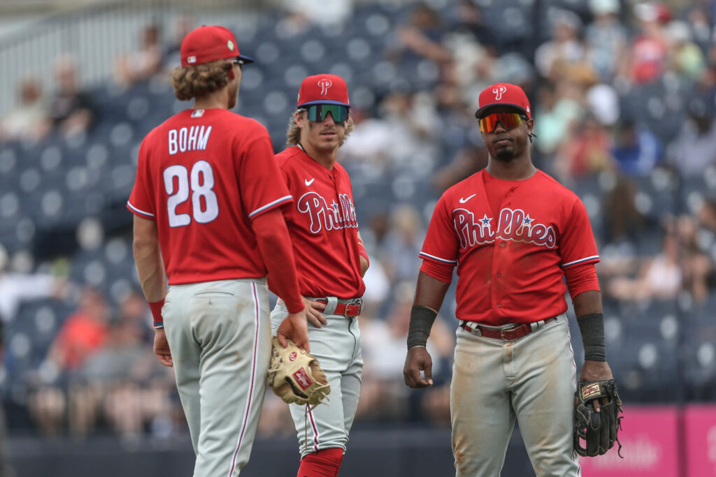 Philadelphia Phillies players Bryson Stott Alec Bohm Jean Segura in red jerseys during game action Wallpaper