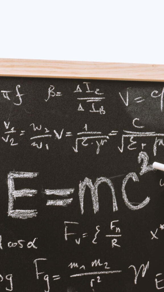 Chalkboard wallpaper with physics equations E equals mc squared white chalk on blackboard background