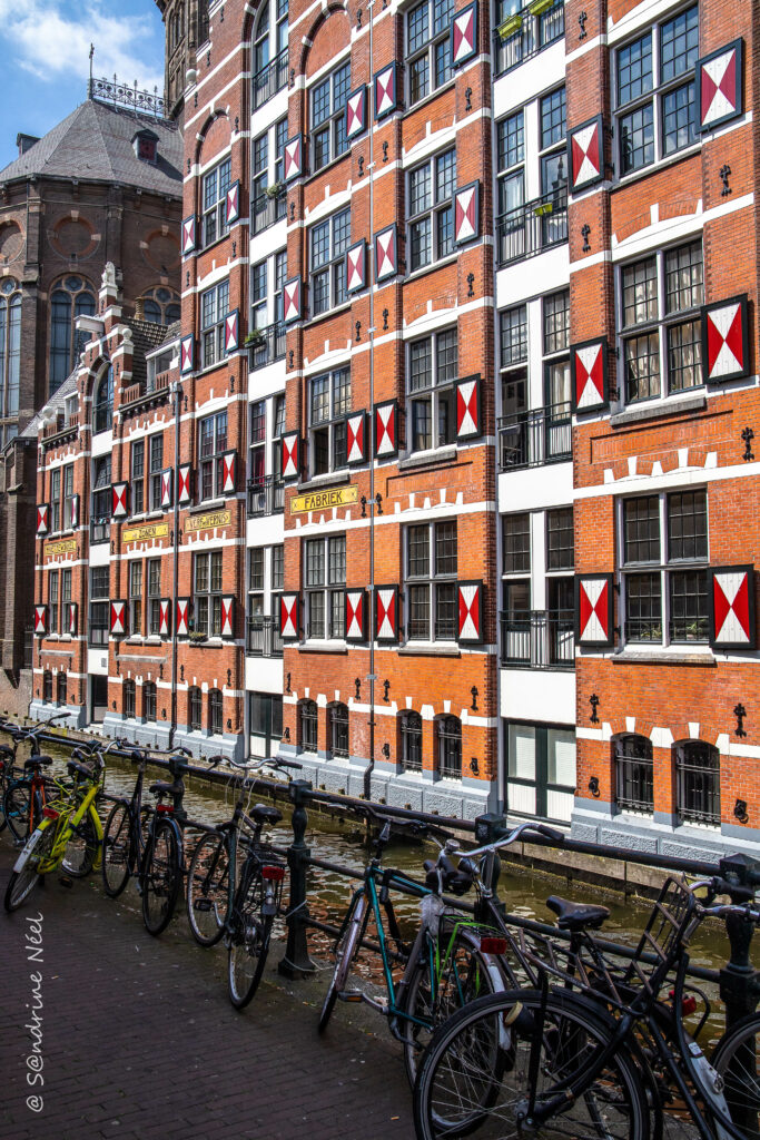 Charming Canal Scene with Bicycles & Red-Brick Architecture Wallpaper