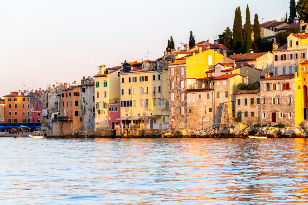 Serene Waterfront Cityscape Wallpaper: Colorful Buildings & Trees