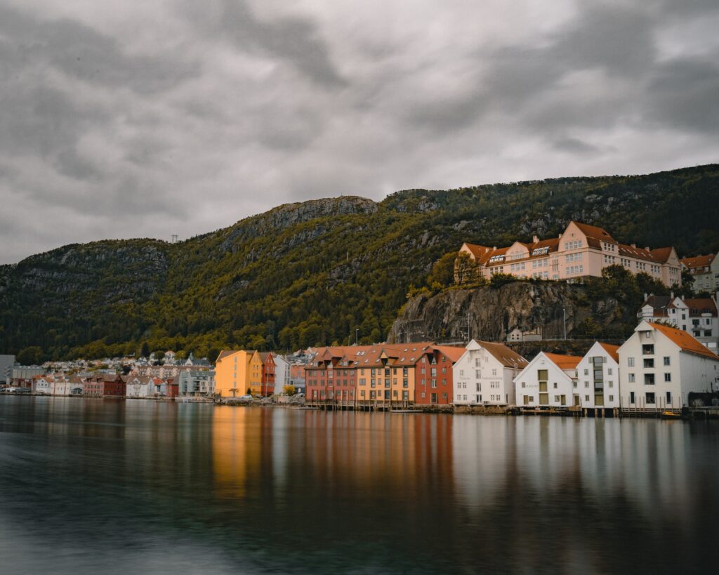 Scenic Coastal Town Wallpaper: Colorful Buildings & Lush Hills
