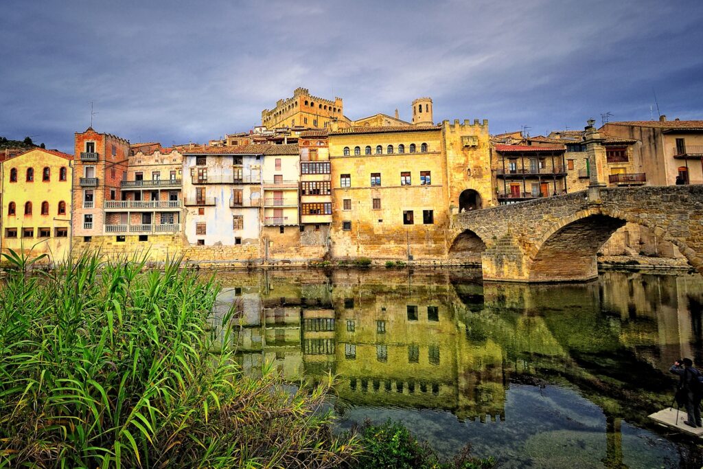 Charming Spanish Town Wallpaper: Historic Bridge & Vibrant Facades