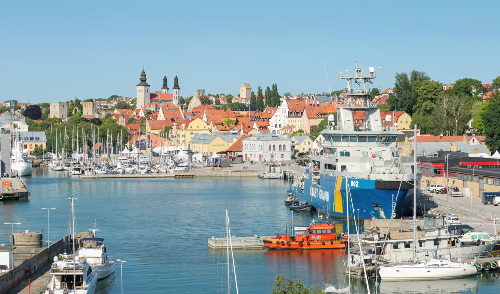 Serene Swedish Harbor Wallpaper: Yachts & Colorful Cityscape
